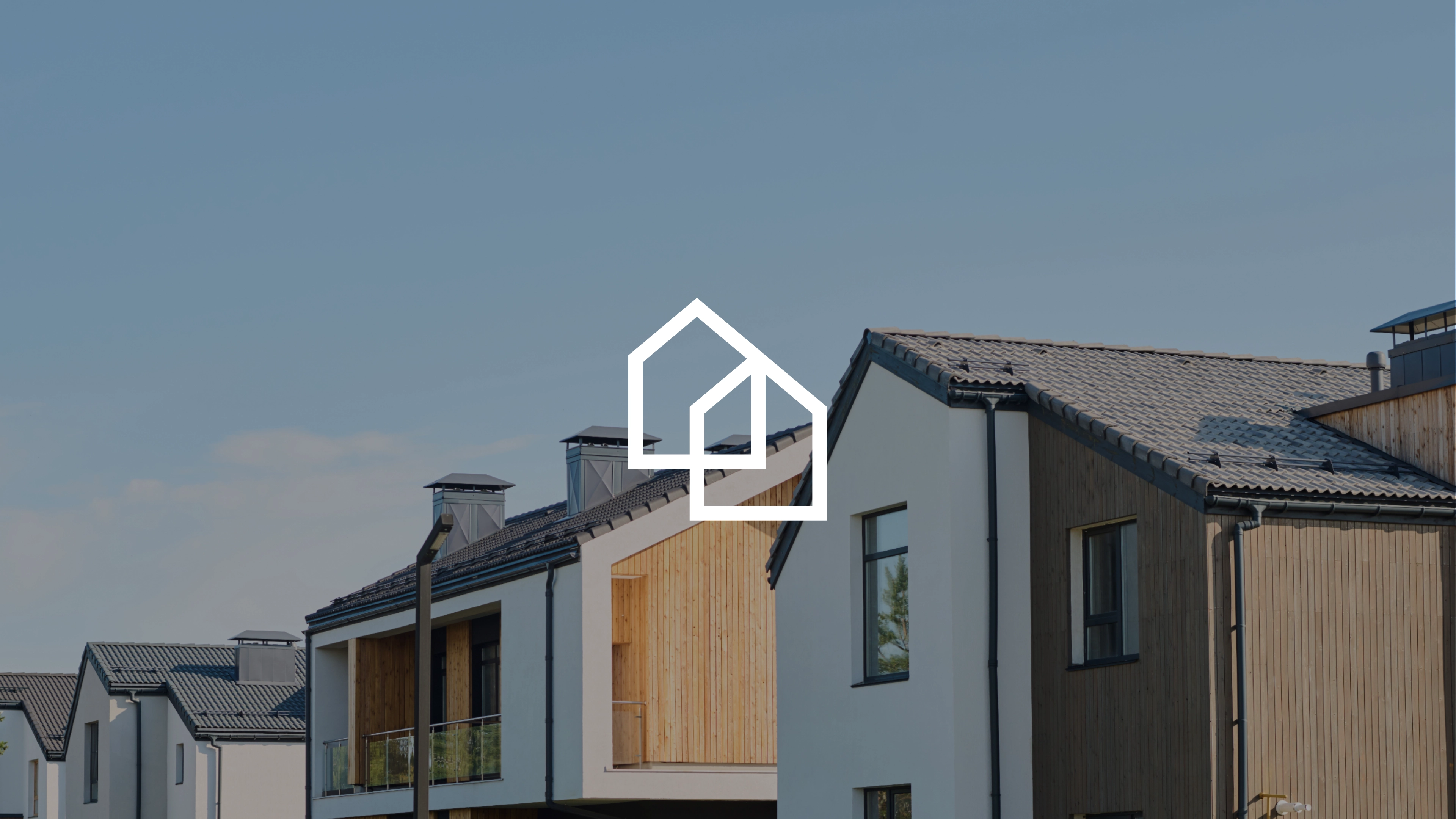 Key visual marki DCI Centre z logo na tle nowoczesnej zabudowy mieszkaniowej.